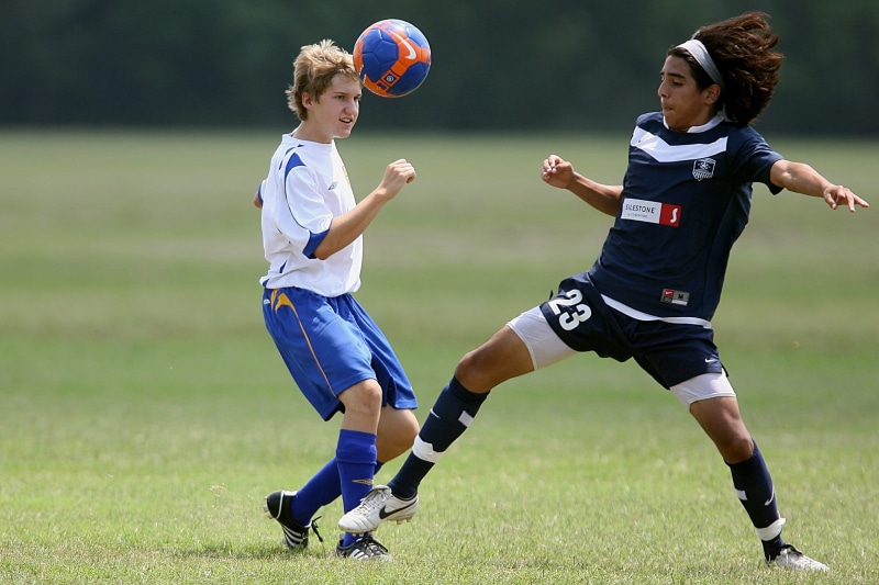 team sport, playing, athlete, sports equipment, youth, ball, adolescence, wear, action, game, outdoors, full length, athletes, green, childhood, fun, team