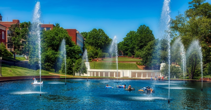 day, landscape, spraying, school, sky, real people, building exterior, plant, tree, frolic, swimming pool, group of people, campus, panorama, architecture