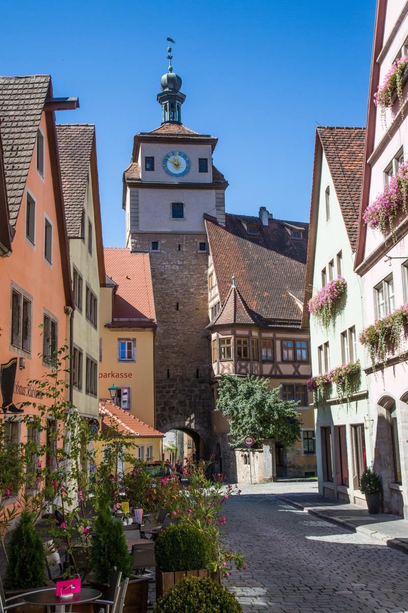 rothenburg of the deaf, town, clear sky, building exterior, sunlight, gate tower, 5K, place of worship, religion, city, built structure, plant, nature