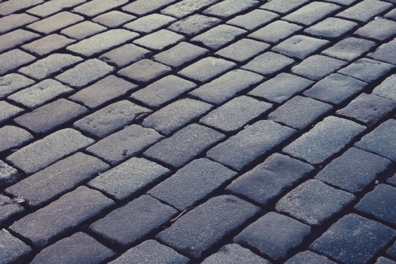 road, outdoors, high angle view, rectangel, stone, close-up, in a row, pattern, 5K, pebble, textured, tourists, car, backgrounds, repetition, people, cobblestone