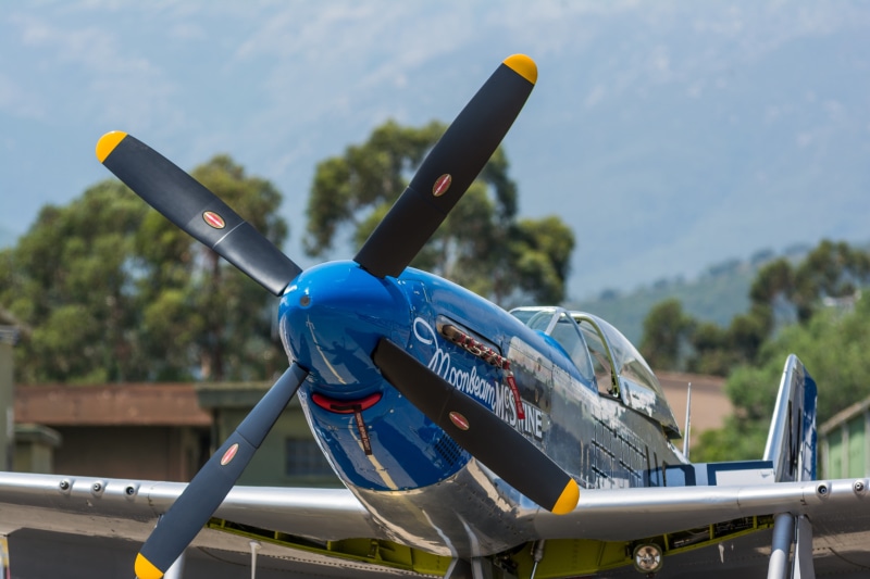 metal, airshows, nature, sunlight, airplane, close-up, air vehicle, no people, propeller, water, focus on foreground, 4K, blue, North American P-51 Mustang