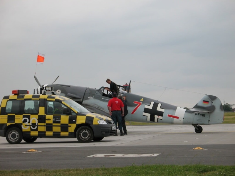 top, military, sky, land vehicle, mode of transportation, vehicle, armed forces, red, military aircraft, car, government, occupation, outdoors, airport runway