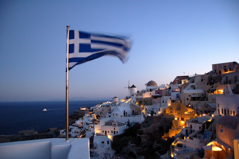 dusk, built structure, clear sky, nature, outdoors, trip, building exterior, wind, ocean, blue, sea, water, city, cityscape, oium, greek flag, santorino