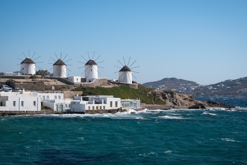 windmills, built structure, copy space, sky, mykonos, clear sky, no people, architecture, mountain, summer, land, beach, beauty in nature, day, sea, explore