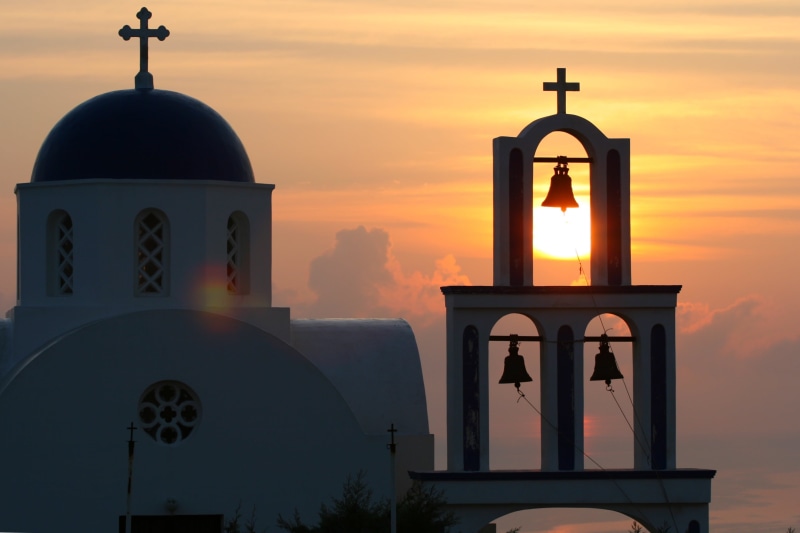 cross, architecture, church, santorini, sunrise, place of worship, sky, sunset, built structure, orange color, greek island, religion, concrete, bells