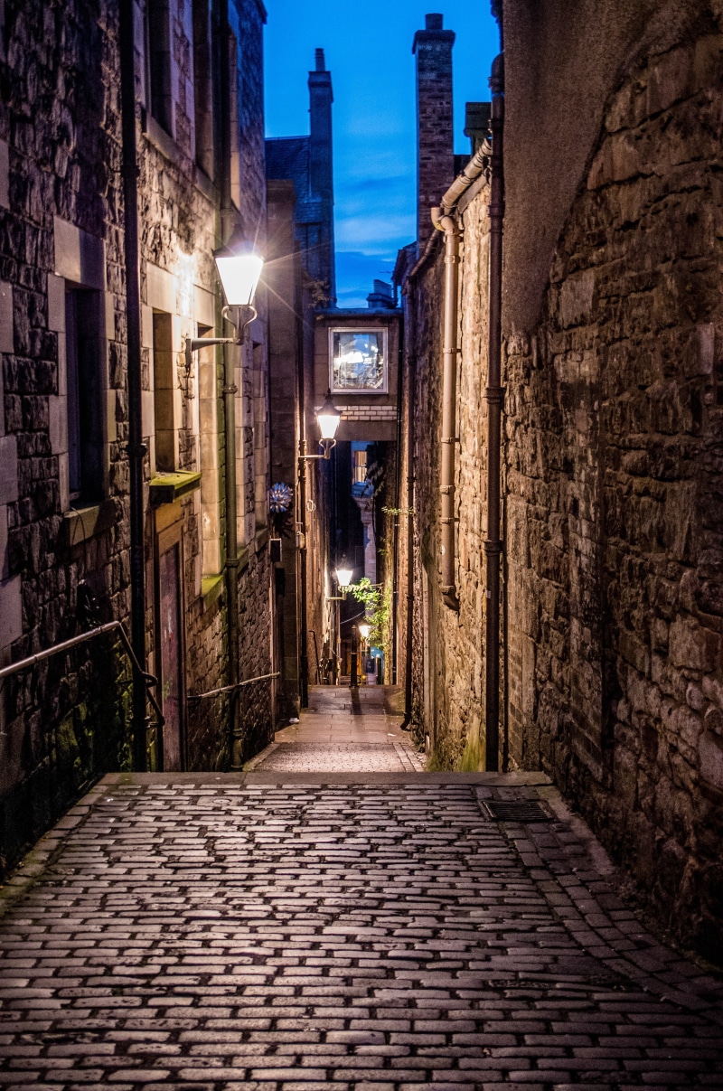 cobblestones, paving stones, paving stone, outdoors, night, travel destinations, real people, lighting equipment, one person, building exterior, anchor close