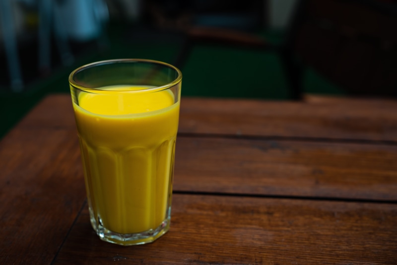 mango lassi, meal, indian restaurant, gate of india, table, refreshment, freshness, close-up, green color, drink, yellow, taste, 5K, indoors, glass, focus on foreground