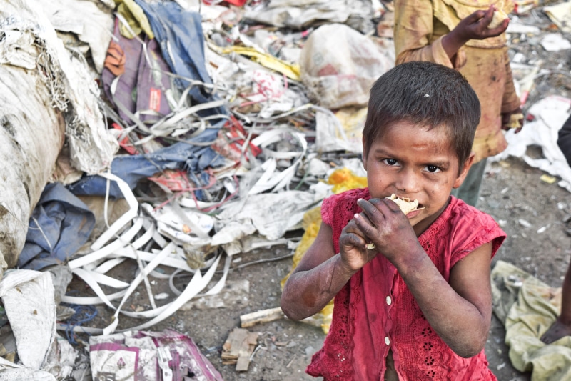 childhood, aggression, casual clothing, slums, human face, child, standing, real people, looking at camera, girl, outdoors, smile, emotion, day, 5K, holding
