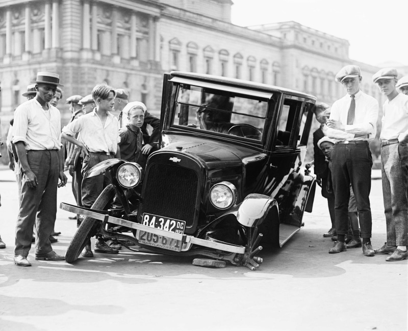 architecture, casual clothing, males, old photos, small group of people, city life, group of people, car, Chevrolet, adult, accidents, full length, day
