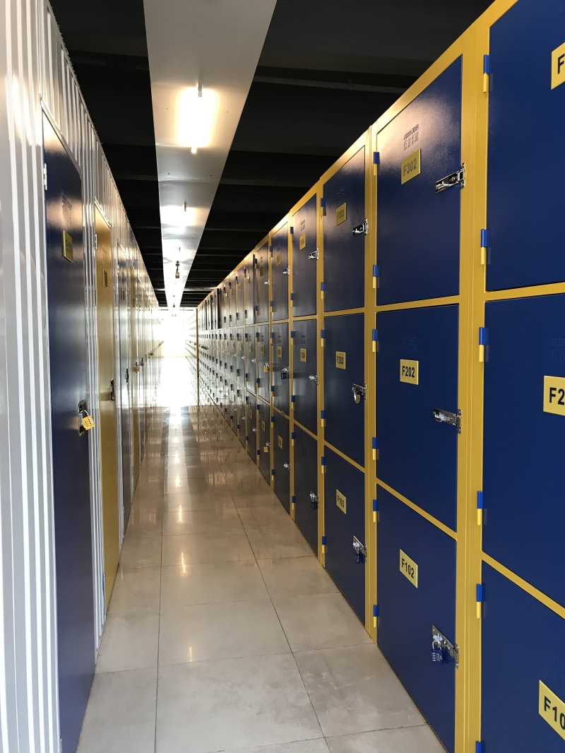 no people, diminishing perspective, flooring, warehouse, music stored music library mini warehouse, indoors, ceiling, self-small warehouse, in a row, lighting equipment