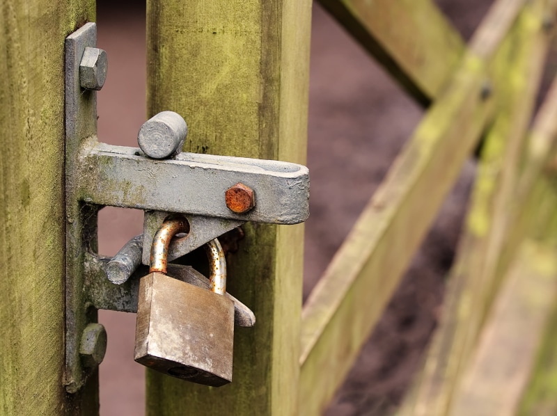 exclusion, old, no people, metal, wood - material, secure, restrict, private, closed, latch, safety, filter, prevent, focus on foreground, boundary, rusty