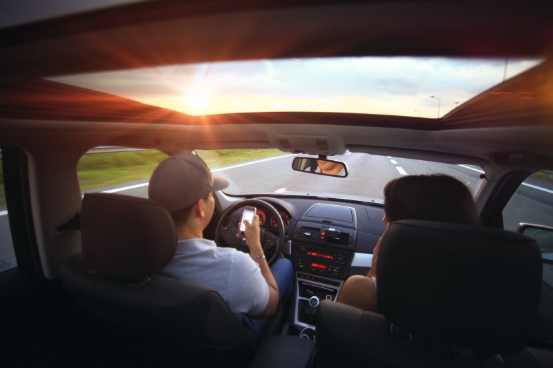 contact, mode of transportation, technology, driving, luxury, freedom, sunset, discussing, vehicle interior, rear view, driver, dangerous, young adult