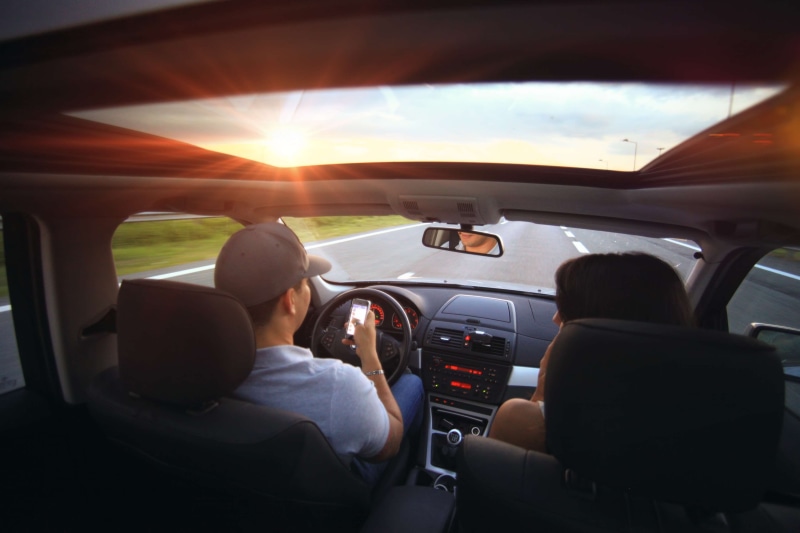 talk, rear view, discussion, technology, indoors, contact, transportation, roadtrip, sitting, women, highway, driving, vehicle interior, mobile phone, sky