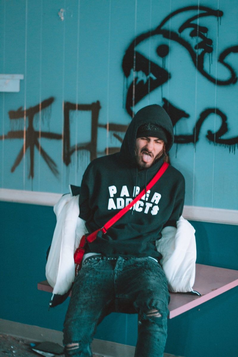 winter, teen, wall - building feature, lil doso, rapper, sitting, addy, warm clothing, text, supreme, illegal, portrait, money, drugs, 5K, criminal, looking at camera