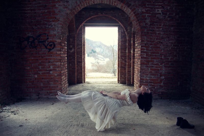 person, brick wall, architecture, full length, people, levitating, fear, young adult, skin, brick, hair, dress, demon, window, daytime, one person, eyes