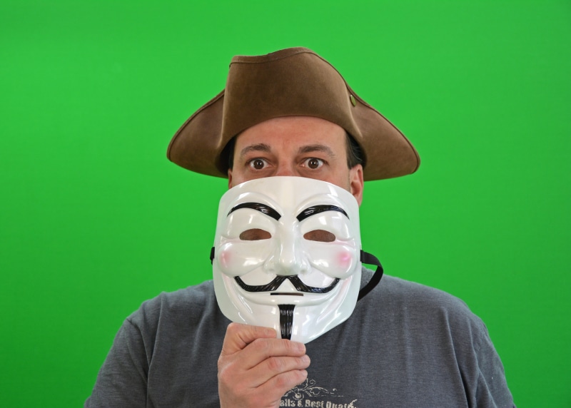indoors, anonymous, holding, security vulnerability, brown, looking at camera, disguise, human body part, hat, studio shot, dressed up, binary, internet