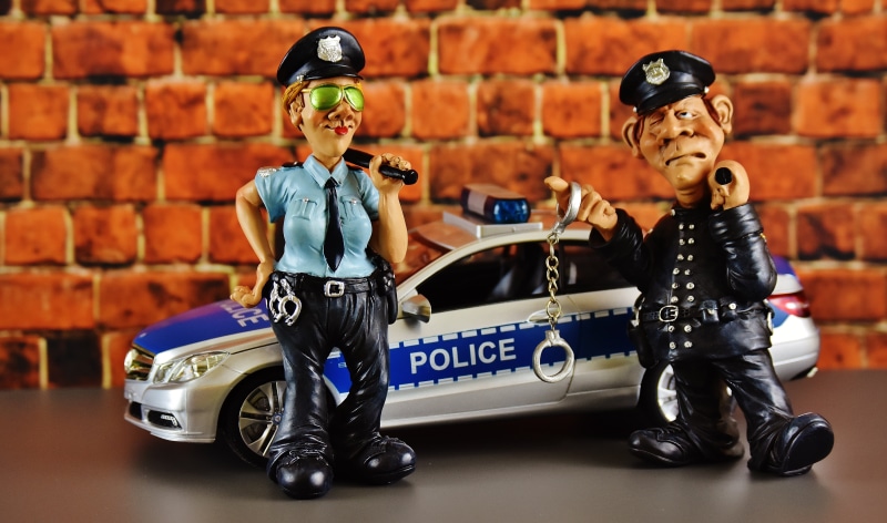 clothing, officer, males, police car, fun, law, fashion, mode of transportation, men, automotive, figure, police check, two people, police Force, brick