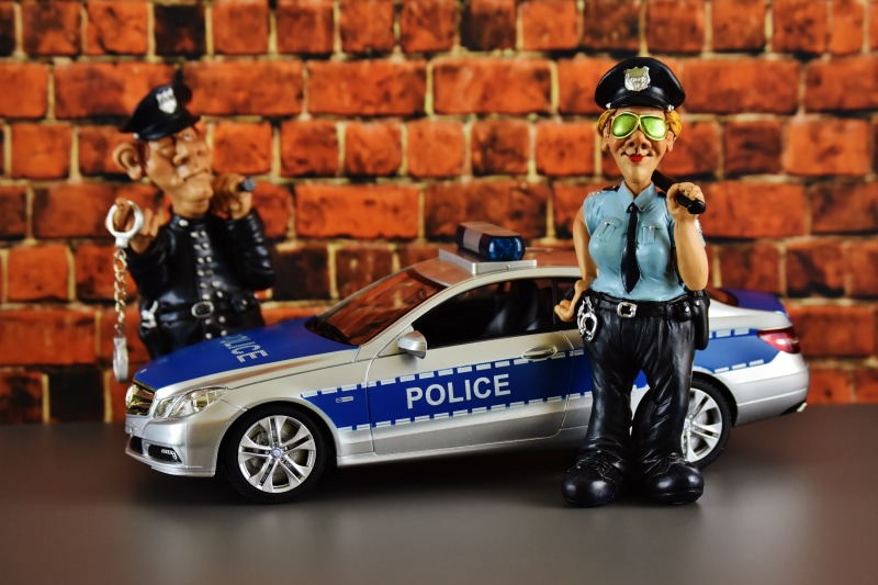 toys, policewoman, fun, boys, police check, one man only, government, transportation, one person, cop, security, model car, brick wall, land vehicle, outdoors