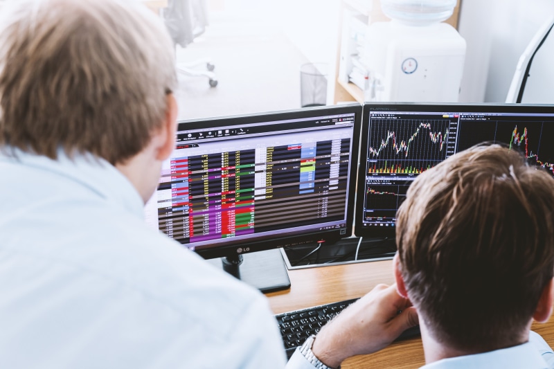 indexes, working, stock, screens, rear view, computer, indoors, table, portrait, males, brokers, people, looking, mature men, numbers, business, headshot