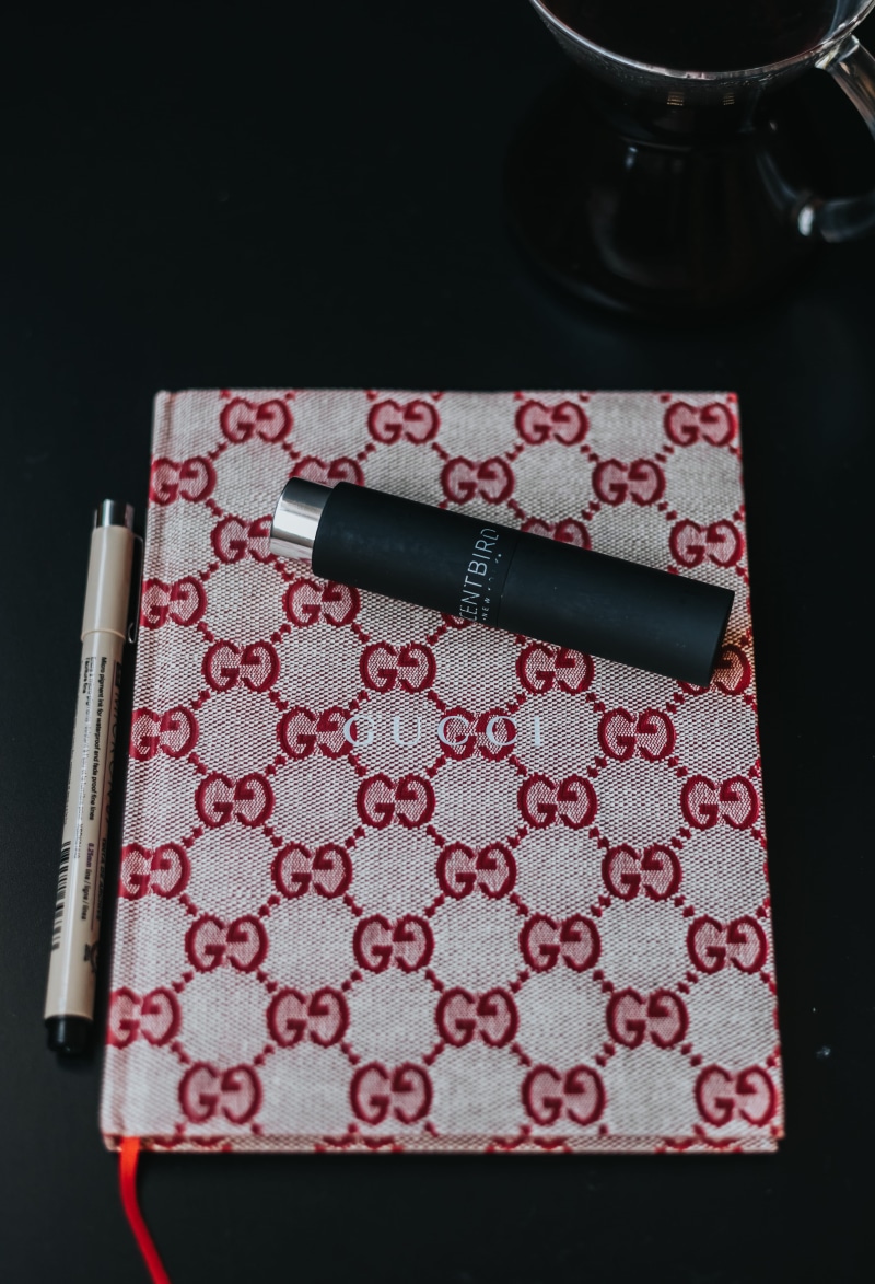 black background, table, no people, indoors, household equipment, file folder, creativity, plectrum, studio shot, leisure activities, marker, diary, red