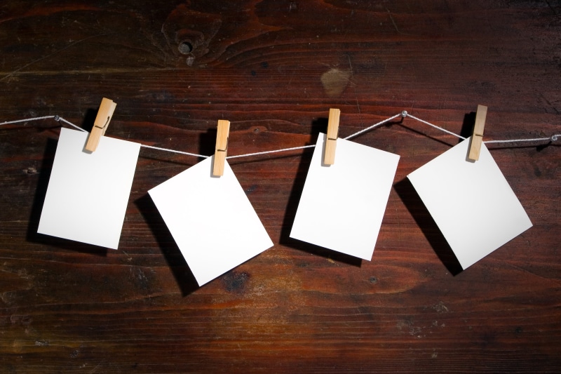 frame, white color, reminder, document, side by side, wood - Material, table, wood, letter, hanging, paper clips, text, white, space, clothing, sheet, still life