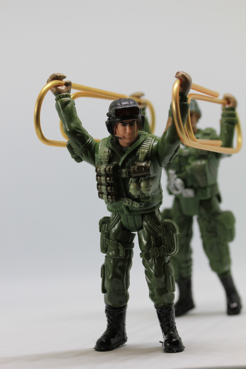 indoors, paperclip, aggression, front view, camouflage, office accessories, military uniform, protection, military, holding, two, weapon, powerful, strong man