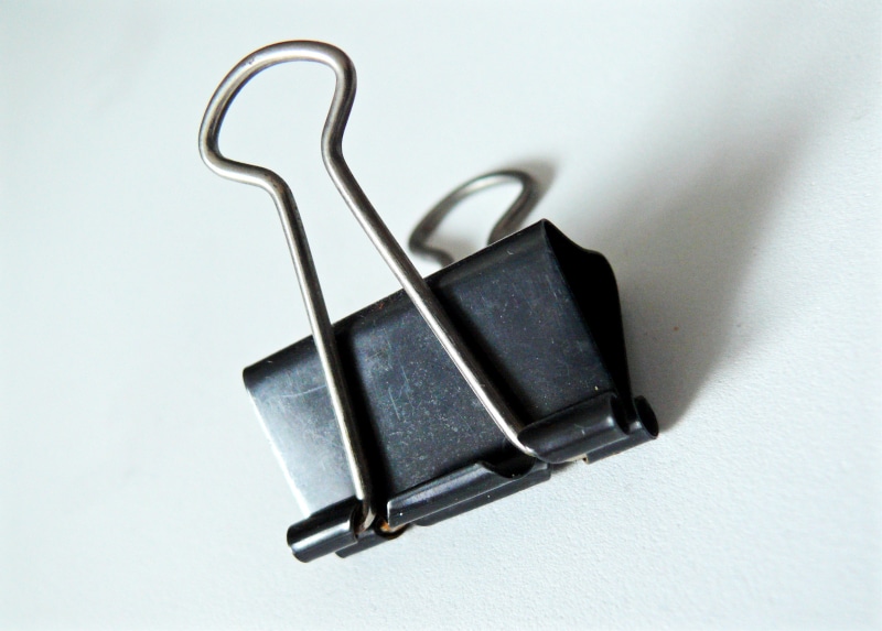 equipment, high angle view, 2K, single object, spring clip, no people, simplicity, connection, steel clamp, still life, shadow, table, studio shot, hanging
