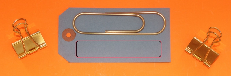 Banner, orange color, sign, paper clip, office supply, group of objects, indoors, colored background, technology, equipment, metal, table, luggage label