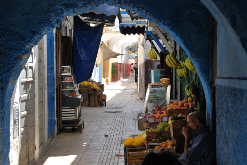 men, small business, africa, souk, day, women, business, city, building, man, passage, building exterior, leaning, adult, music, fruit, footpath, wall