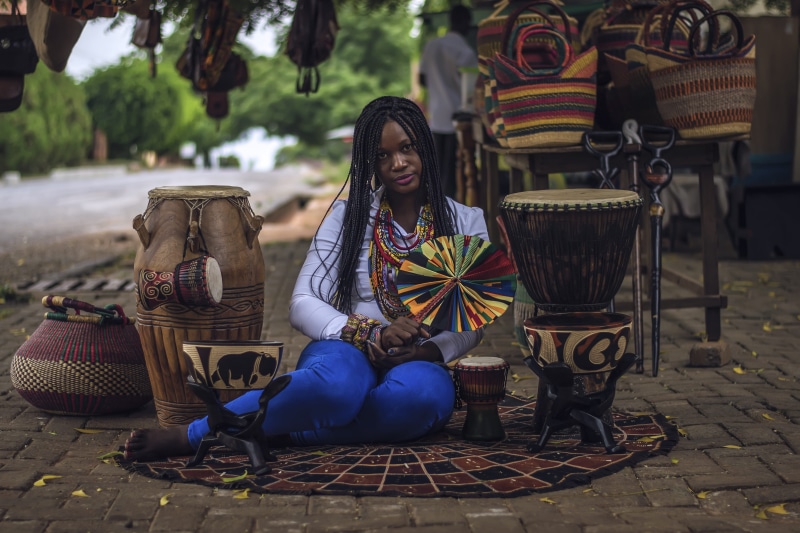 basket, women, adult, pavement, sticks, trader, drums, sitting, casual clothing, holding, african, 4K, wind, seat, lifestyles, tree, bongo, day, braids