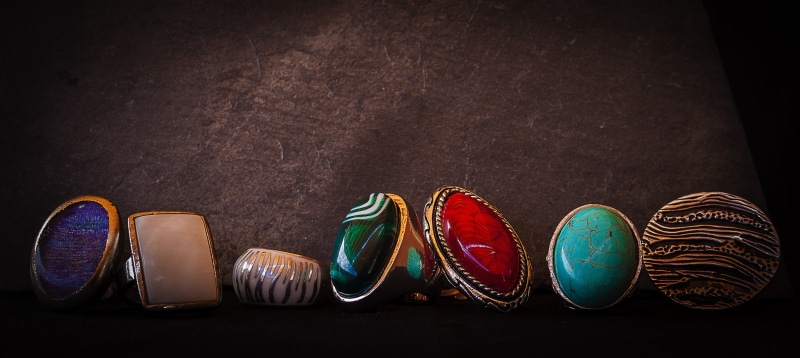 personal accessory, indoors, studio shot, no people, rings, multi colored, ornate, diamonds, pair, group of objects, ring, sandal, in a row, medium group of objects