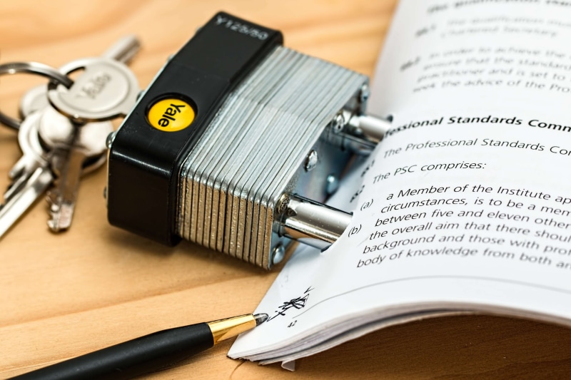 commitment, personal accessory, close-up, negotiation, obligat, locked, no people, protection, lock, indoors, studio shot, table, key, text, safety, focus on foreground