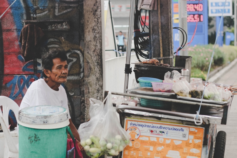 person, market, day, kiosk, retail display, men, white, selling, newsstand, one person, mature men, food, guy, outdoors, portrait, cook, three quarter length