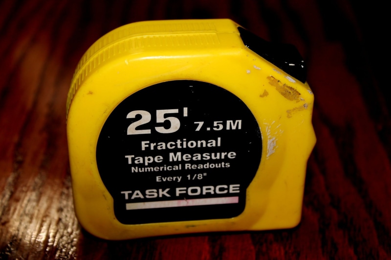 communication, capital letter, single object, information, task force, wood - material, indoors, close-up, food, measuring tape, sign, focus on foreground