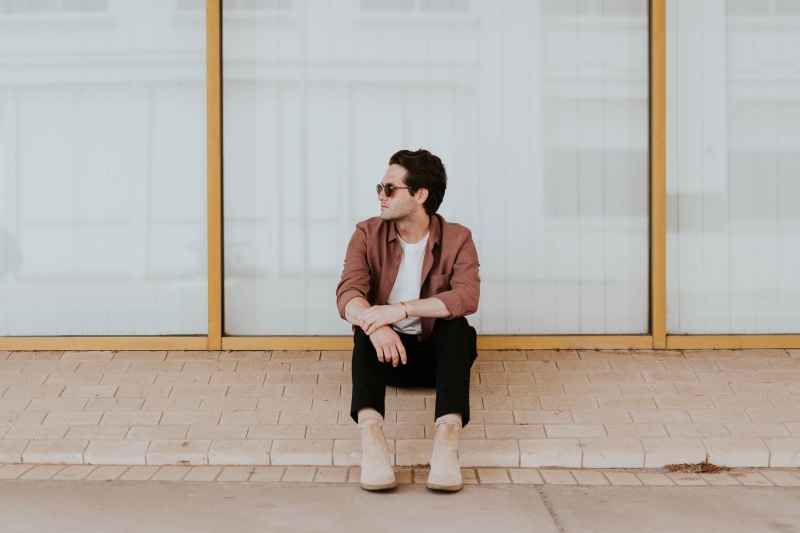 brown, outdoors, shirt, male, built structure, indoors, contemplation, fashion, shoes, people, man, day, front view, education, beside, mobile Phone, red