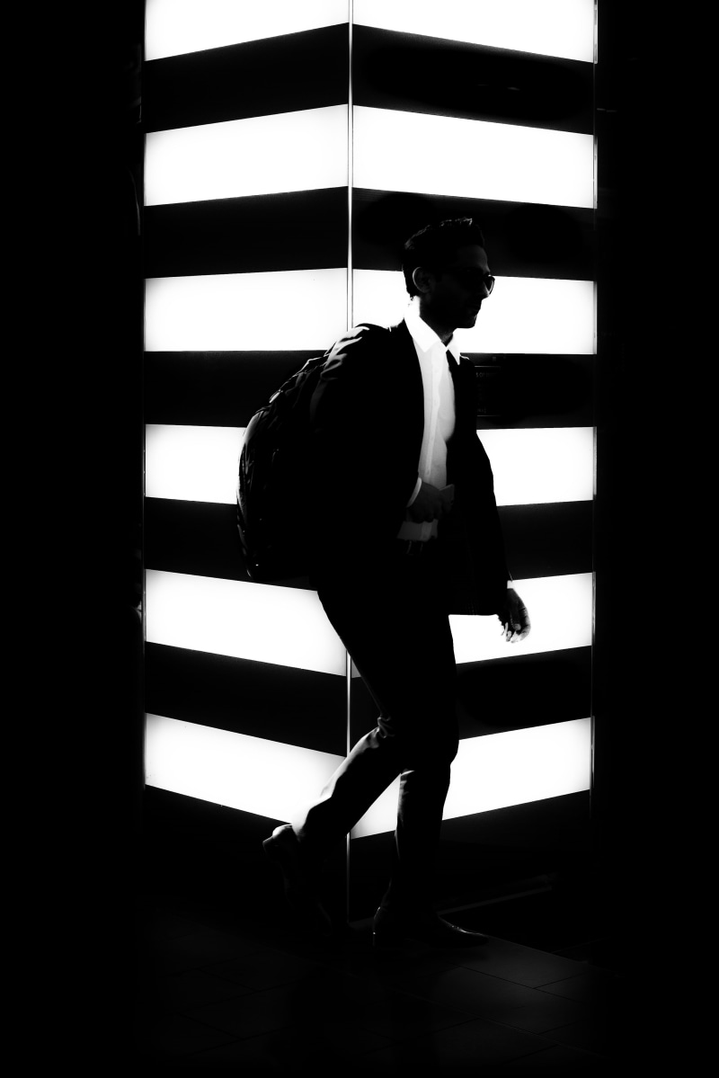 people, contemplation, one Person, black suit, indoors, button, day, mid adult, man, jacket, adults only, shadow, adult, suit, window, black and white