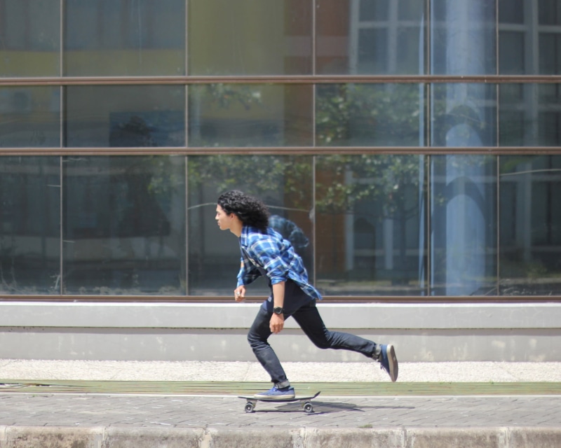 built structure, building, skateboard, young adult, day, adults only, only men, wearing, riding, young men, footwear, side view, skateboarding, casual clothing