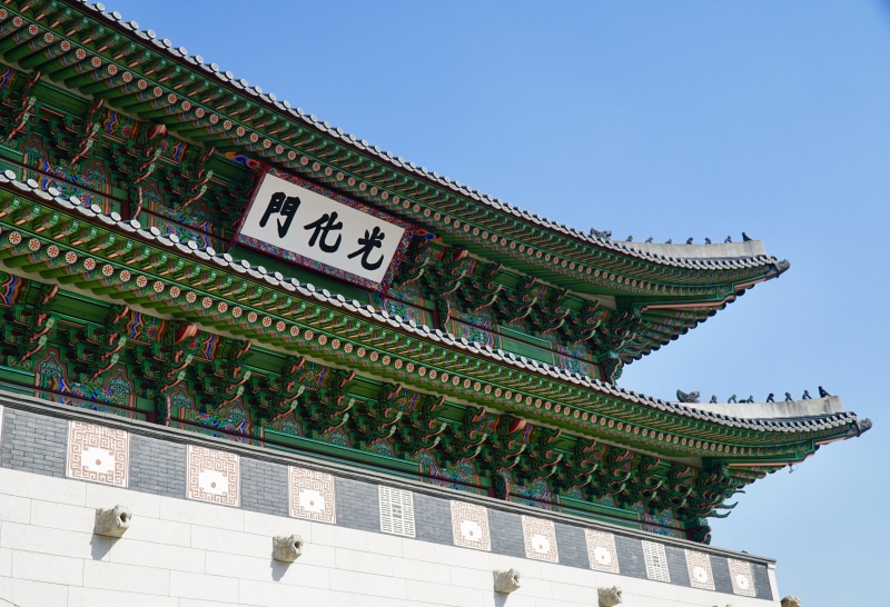 clear sky, building exterior, travel destinations, ornate, no people, sky, roof, architecture, korea, building, low angle view, built structure, gwanghwamun