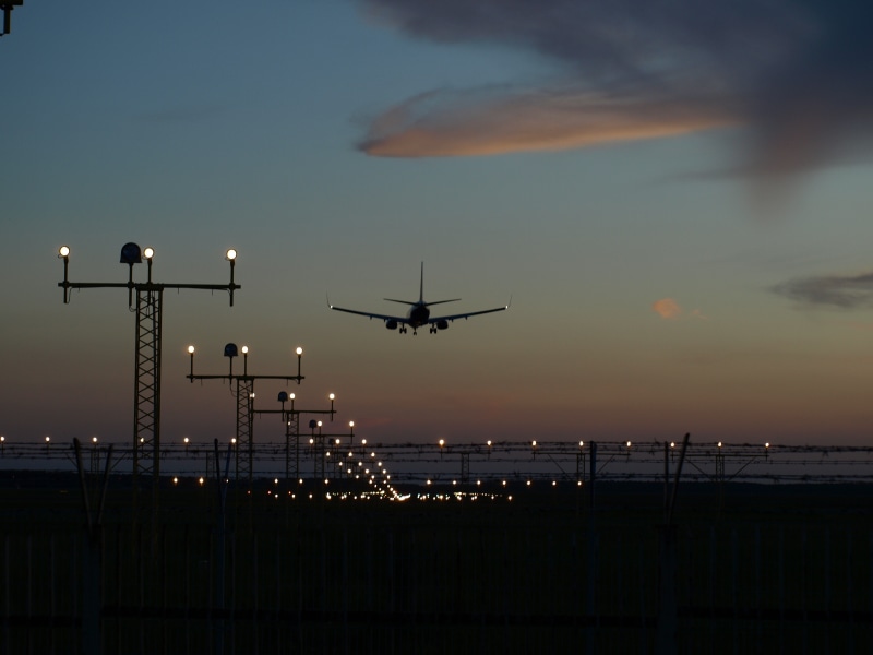 silhouette, airliner, sky, built structure, transportation, plane, nature, runway, cloud - sky, aircraft, landing, lighting equipment, jet, illuminated