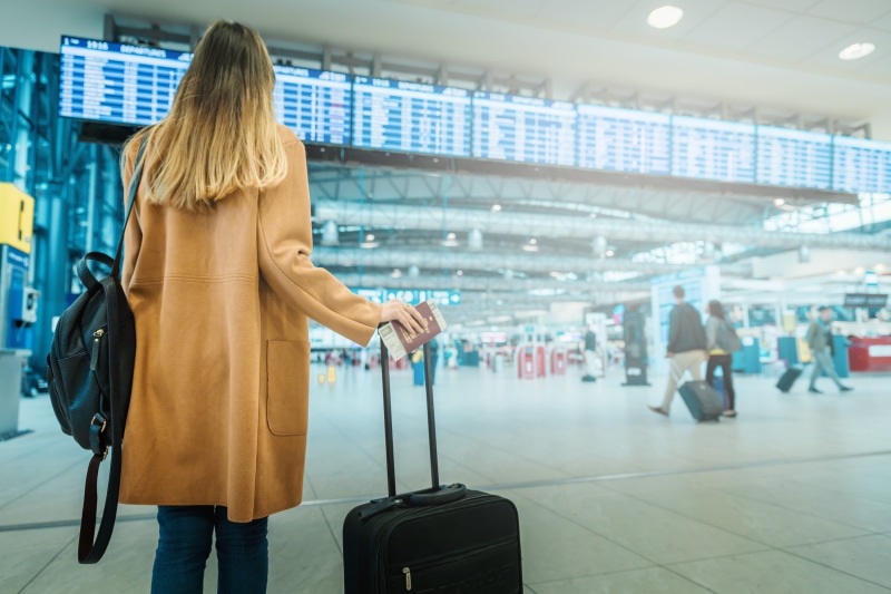 standing, business, one person, young, airport check-in counter, luggage, leaving, travel, suitcase, bag, coat, hair, indoors, journey, airport terminal