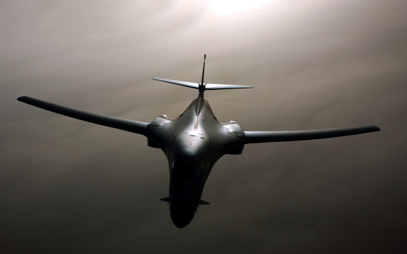 low angle view, 2K, aircraft, directly below, front view, air vehicle, single object, commercial airplane, outdoors, Rockwell B-1 Lancer, day, no people