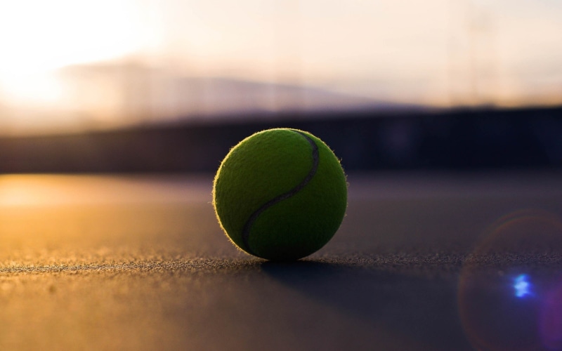 sport, focus on foreground, outdoors, green, tennis balls, blurred, sphere, 2K, ball, close-up, recreational pursuit, leisure activity, tennis ball, selective focus