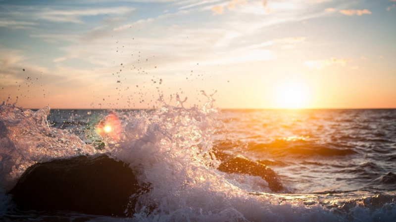 outdoors, nature, rock, lens flare, power in nature, sea, beach, land, horizon, wave, splashing, beauty in nature, sky, sunlight, horizon over water, sunset