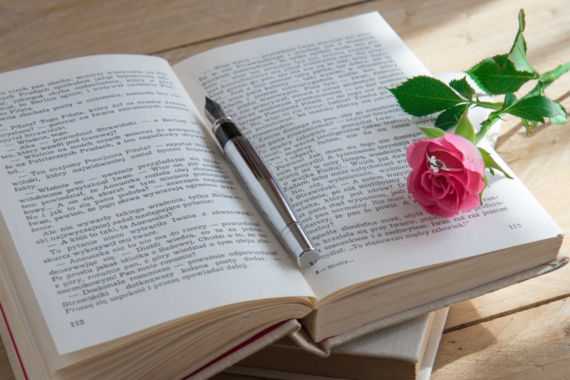 no people, paper, day, rose, still life, education, flowering plant, western script, open, print, old book, plant, spirituality, page, textbook, beside