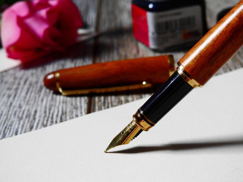 wood - material, close up, pen, wood, book, writing instrument, flower, document, writing, focus on foreground, rose, close-up, no people, fountain pen
