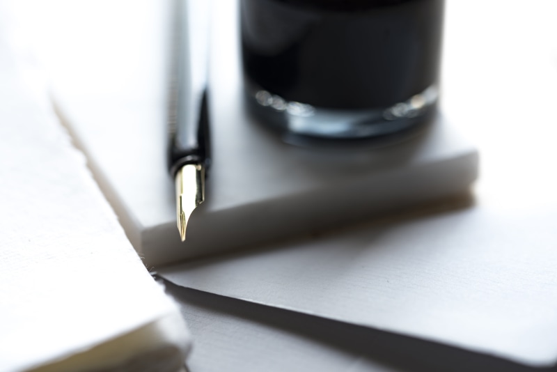 light, selective focus, drink, indoors, studio shot, extreme close-up, note pad, clear, analogue, beside, fountain pen, write, notebook, no people, writing instrument