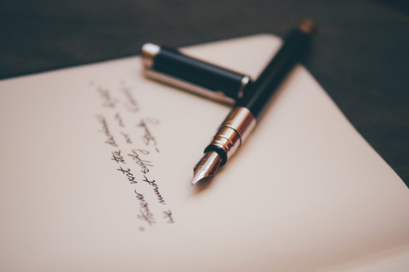 signing, silver, black, paper, pen, nib, calligraphy, letter, two objects, communication, ink, no people, indoors, close-up, document, writing, book, still life