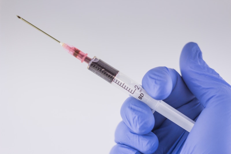 one person, holding, research, studio shot, person, virus, science, injecting, needle, doctor, white, blood, occupation, protective workwear, healthcare And Medicine