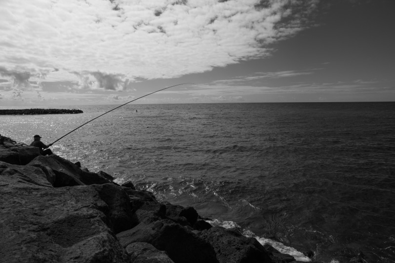 real people, beauty in nature, Azores, activity, horizon over water, rock, monochrome, horizon, tranquil scene, fisherman, fishing rod, sea, sky, outdoors