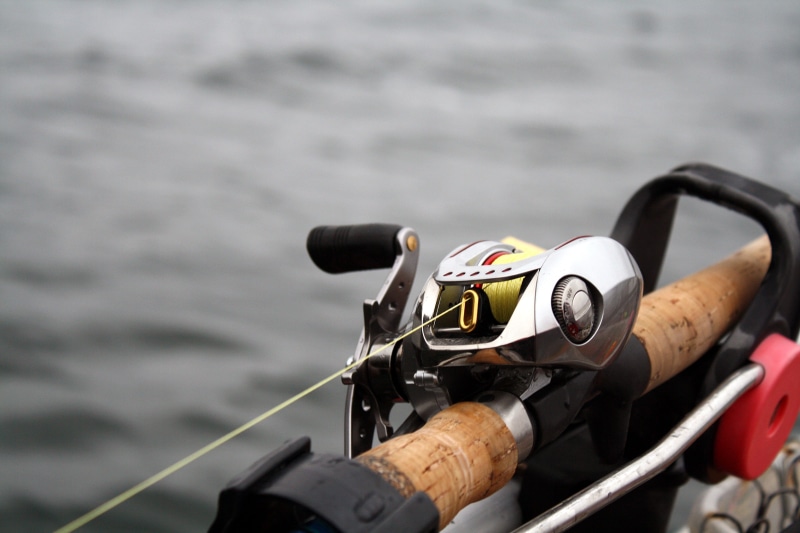 no people, selective focus, sea, holder, focus on foreground, outdoors, daiwa, still life, line, water, transportation, fishing, rod, food and drink, close-up